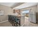 Wet bar features seating for four, granite countertops, stainless steel appliances, and sliding glass doors to backyard at 3255 Waterfront Dr, Monument, CO 80132