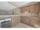 Elegant wet bar offers stainless steel appliances, wine cooler, granite countertops, and wooden cabinets at 3255 Waterfront Dr, Monument, CO 80132