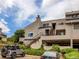 Exterior shot of the residence highlighting the access stairs and parking areas at 1820 Newland Ct # 201, Lakewood, CO 80214