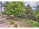 Lush backyard landscaping with trees, pathway and a water feature creates a serene outdoor setting at 8216 S Krameria Way, Centennial, CO 80112