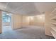 Spacious finished basement with paneled walls, carpet flooring, and shelving at 8216 S Krameria Way, Centennial, CO 80112