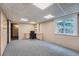 Finished basement with a desk, office chair, shelving, and window view to the outside at 8216 S Krameria Way, Centennial, CO 80112