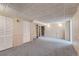 Finished basement boasts shelving and closet space in a neutrally painted space with carpet at 8216 S Krameria Way, Centennial, CO 80112