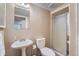 Bathroom features textured walls, a pedestal sink and a shower with glass doors at 8216 S Krameria Way, Centennial, CO 80112