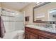 Bathroom features a granite vanity, a large mirror and a tiled shower with glass doors at 8216 S Krameria Way, Centennial, CO 80112