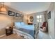 Comfortable bedroom with a brass bed, side table, lamps, and neutral walls at 8216 S Krameria Way, Centennial, CO 80112