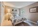 Well-lit bedroom with a white metal bed frame, neutral walls, and plush carpet at 8216 S Krameria Way, Centennial, CO 80112