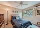 Cozy bedroom features a ceiling fan, a window and a comfortable bed with stylish bedding at 8216 S Krameria Way, Centennial, CO 80112