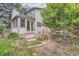 Charming home's exterior with a patio and a balcony nestled in lush greenery and meticulous landscaping at 8216 S Krameria Way, Centennial, CO 80112