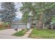 Charming two-story home featuring a three-car garage and a beautifully landscaped front yard with mature trees at 8216 S Krameria Way, Centennial, CO 80112