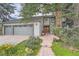 Inviting home exterior featuring a brick pathway leading to a double-door entrance and a well-manicured front yard at 8216 S Krameria Way, Centennial, CO 80112