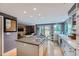 Open kitchen features a center island with cooktop and easy access to the living room at 8216 S Krameria Way, Centennial, CO 80112