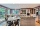 Well-lit kitchen featuring an island with range, granite counters, seating area, and ample storage at 8216 S Krameria Way, Centennial, CO 80112