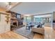 Cozy living room features a fireplace, hardwood floors, and an open floor plan to the kitchen at 8216 S Krameria Way, Centennial, CO 80112