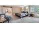 Spacious main bedroom featuring soft carpet, natural light, a king size bed and ensuite bath at 8216 S Krameria Way, Centennial, CO 80112