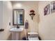 Charming powder room features elegant textures, a pedestal sink, and attractive accents at 8216 S Krameria Way, Centennial, CO 80112