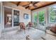 Relaxing sunroom features ceiling fan, natural light from many windows, and tile flooring at 8216 S Krameria Way, Centennial, CO 80112