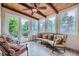 Bright sunroom with wood ceiling, tiled floors, backyard access, and comfortable seating at 8216 S Krameria Way, Centennial, CO 80112