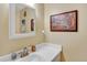 Powder room featuring a white sink, faucet, and framed artwork at 7040 E Girard Ave # 406, Denver, CO 80224