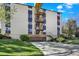 This tan apartment building has an emergency staircase and a covered garage at 7040 E Girard Ave # 406, Denver, CO 80224
