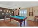 Game room featuring a billiards table, stylish lighting, and access to an outdoor patio at 7040 E Girard Ave # 406, Denver, CO 80224