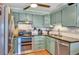 Updated kitchen with stainless steel appliances, granite countertops, and vintage-style cabinets at 7040 E Girard Ave # 406, Denver, CO 80224