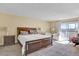 Spacious main bedroom with a private balcony, cozy seating, and large windows at 7040 E Girard Ave # 406, Denver, CO 80224