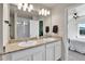 This bathroom features double sinks, granite counters, and modern lighting at 6459 N Dunkirk St, Denver, CO 80249