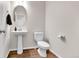 This bathroom features a pedestal sink, a white toilet, and modern fixtures at 6459 N Dunkirk St, Denver, CO 80249
