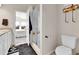 This bathroom features a glass shower and white cabinets at 6459 N Dunkirk St, Denver, CO 80249