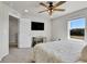 This bedroom features neutral carpet, a ceiling fan and natural light at 6459 N Dunkirk St, Denver, CO 80249