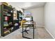 Bedroom with neutral carpet, a dark desk, black shelving, and bright natural light at 6459 N Dunkirk St, Denver, CO 80249