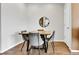 Dining area featuring seating for four, wood floors, and modern decor at 6459 N Dunkirk St, Denver, CO 80249