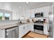 Contemporary kitchen with stainless steel appliances, granite countertops, and white cabinetry at 6459 N Dunkirk St, Denver, CO 80249