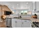 This kitchen features granite counters, stainless steel appliances, and white cabinetry at 6459 N Dunkirk St, Denver, CO 80249