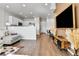 Bright open-concept living area with hardwood floors, modern decor, and a view of the kitchen at 6459 N Dunkirk St, Denver, CO 80249