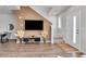 Inviting living area with hardwood floors, staircase, and natural light from the entry door at 6459 N Dunkirk St, Denver, CO 80249