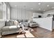 Cozy living room with a plush gray sectional sofa and abundant natural light from a window at 6459 N Dunkirk St, Denver, CO 80249