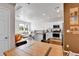 Open floor plan with stainless steel appliances and a view into the living room from the kitchen at 6459 N Dunkirk St, Denver, CO 80249