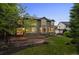 Charming backyard features a stone patio, mature trees, and a lush green lawn at 10524 Serengeti Dr, Lone Tree, CO 80124