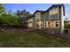 Exterior showcasing a large, grassy backyard and a cozy stone patio at 10524 Serengeti Dr, Lone Tree, CO 80124
