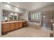 A bathroom boasts a soaking tub, glass shower, and double vanity at 10524 Serengeti Dr, Lone Tree, CO 80124