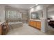 A bathroom offers a glass shower, soaking tub, and vanity area at 10524 Serengeti Dr, Lone Tree, CO 80124