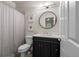 A bathroom features a modern vanity, toilet, and shower with a curtain at 10524 Serengeti Dr, Lone Tree, CO 80124