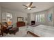 A bedroom features a ceiling fan, shuttered windows, and comfortable furniture at 10524 Serengeti Dr, Lone Tree, CO 80124