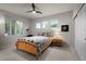 A cozy bedroom offers natural light and neutral color scheme at 10524 Serengeti Dr, Lone Tree, CO 80124