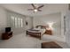 A well-lit bedroom is complete with a ceiling fan and ample natural light at 10524 Serengeti Dr, Lone Tree, CO 80124