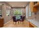 Bright dining area features a glass table and seating for four near large windows at 10524 Serengeti Dr, Lone Tree, CO 80124