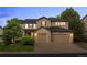 Charming two-story home boasts a two-car garage, manicured lawn, and brick accents at 10524 Serengeti Dr, Lone Tree, CO 80124