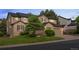 This two-story home offers a manicured lawn and mature trees at 10524 Serengeti Dr, Lone Tree, CO 80124